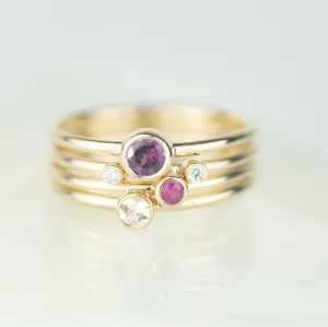 Cassiopeia - Rhodolite Garnet, Ruby, White Sapphire and Diamond Gold Stacking Ring Set Cassiopeia - Rhodolite Garnet, Ruby, White Sapphire and Diamond Gold Stacking Ring Set